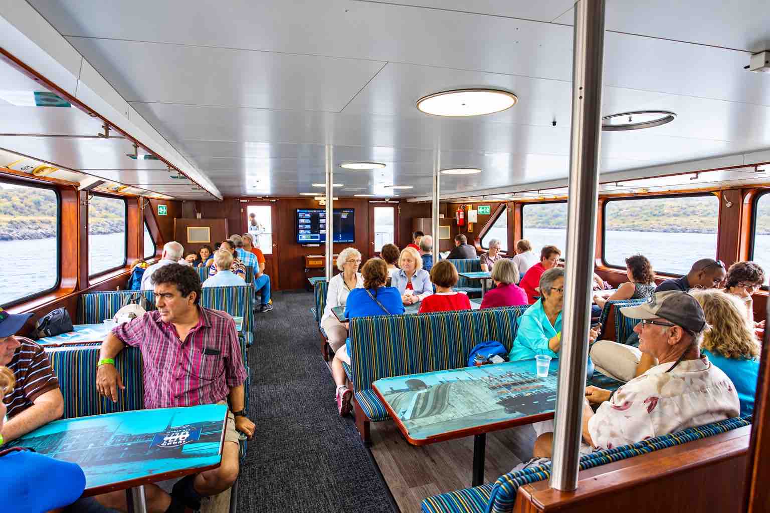 Panama Canal partial transit tour: guests seated at tables inside the Pacific Queen.