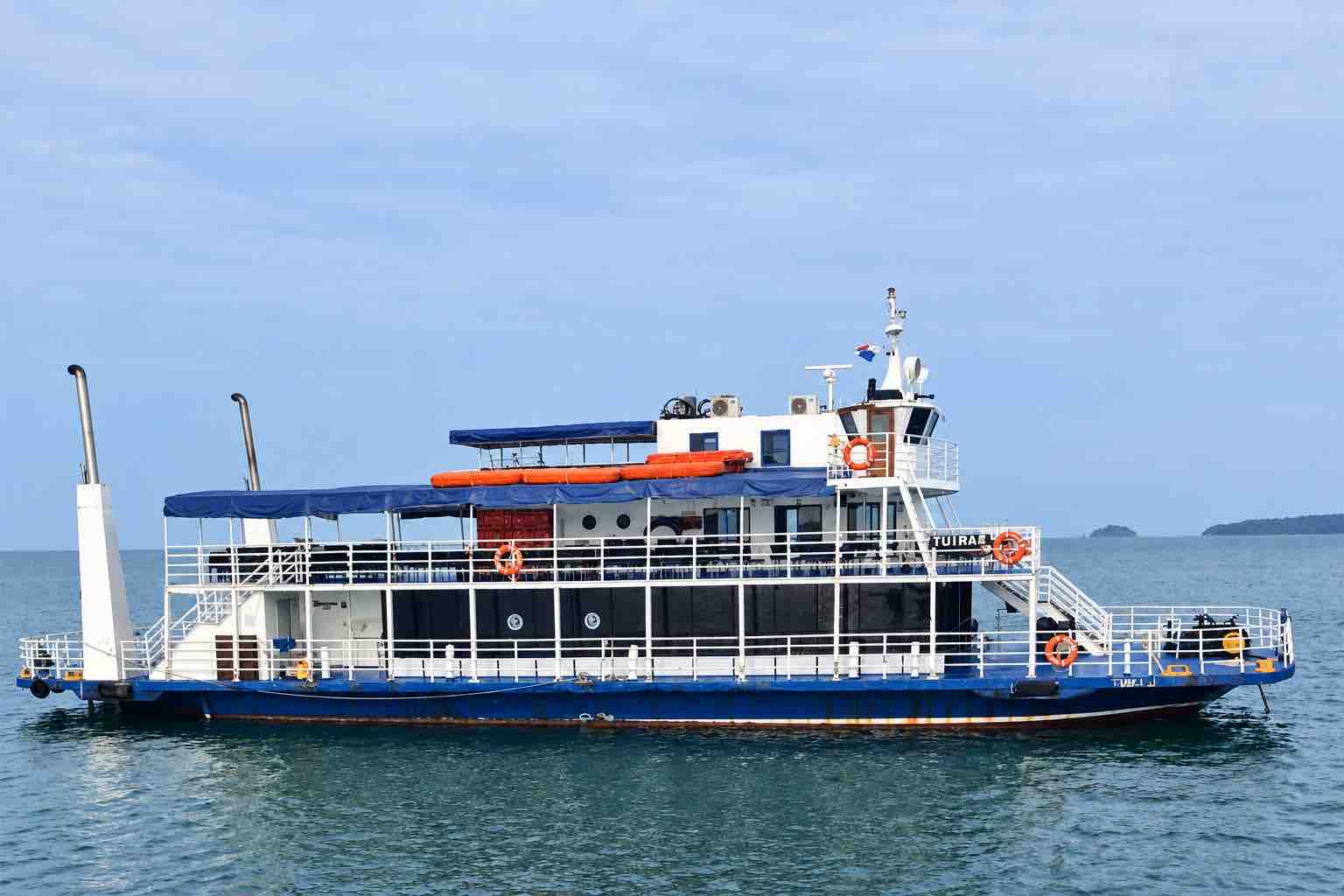 Panama Canal partial transit tour: side view of the Tuira II passenger boat on the water.