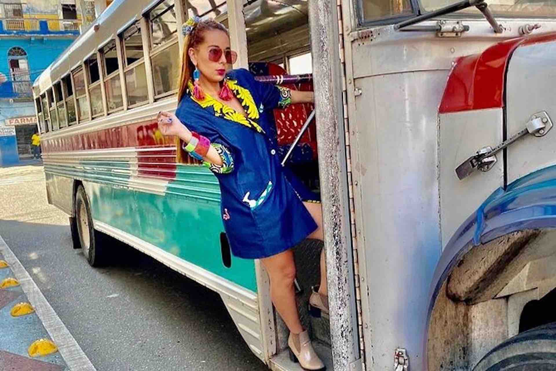 Casco Viejo Walking Tour image: woman posing on the step of a vintage bus