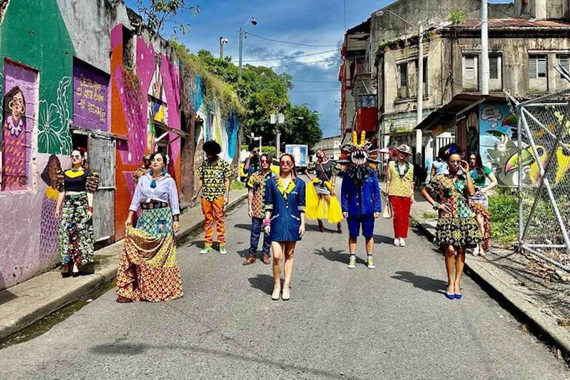 Casco Viejo Walking Tour image: group walking along a street beside colorful textiles and historic buildings