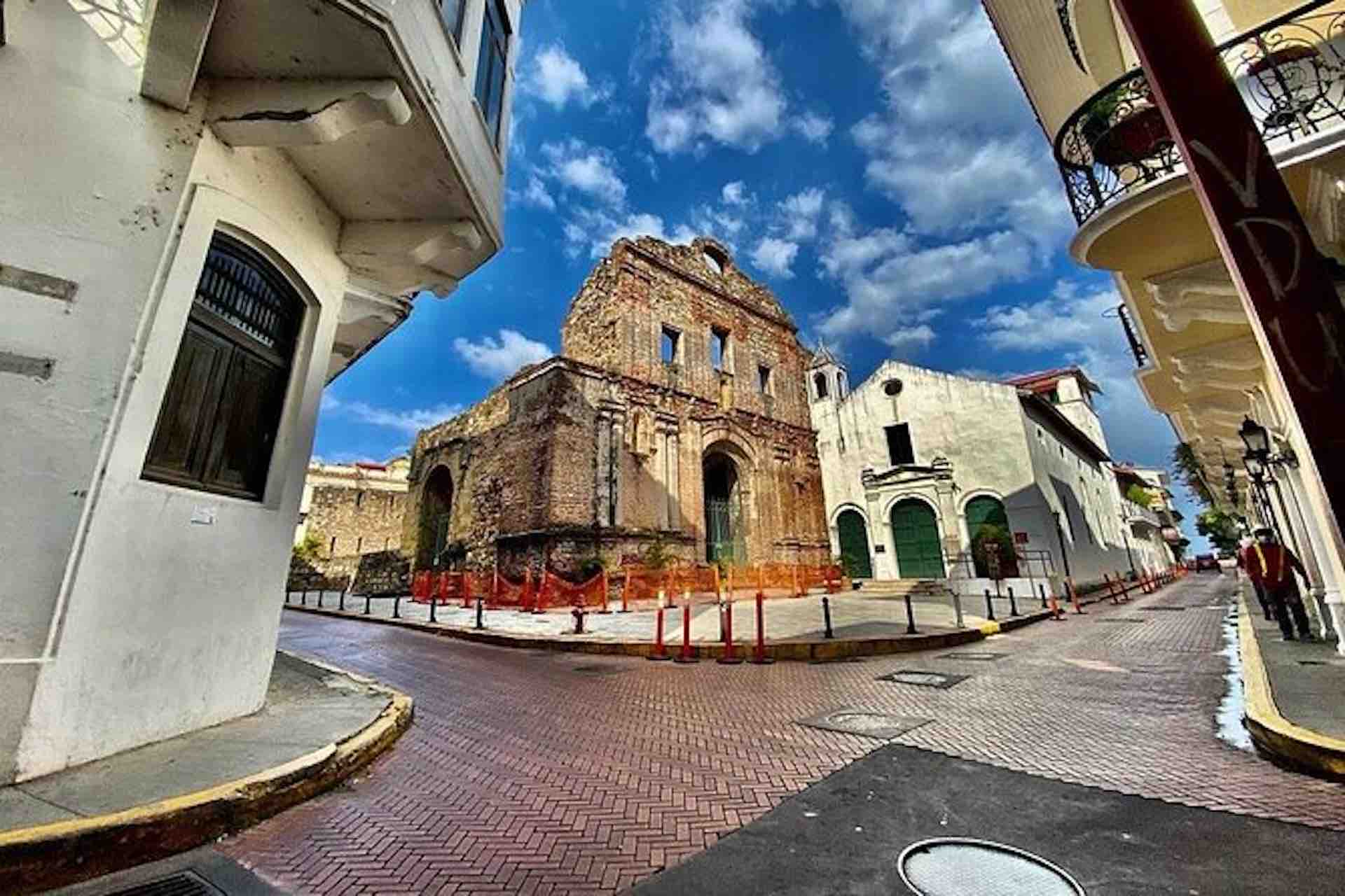 Casco Viejo Walking Tour image: historic stone church facade at a street corner surrounded by balconies