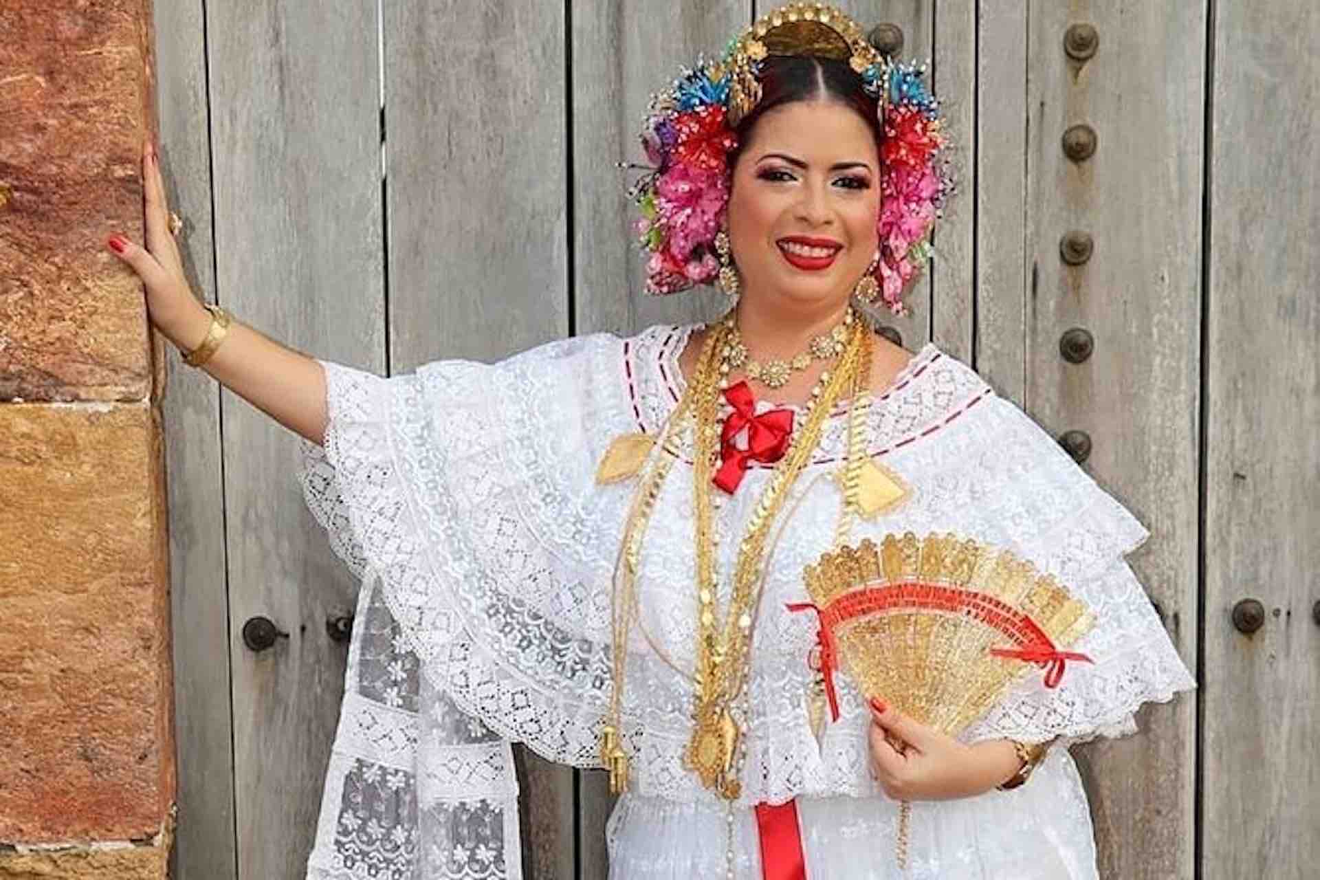 Casco Viejo Walking Tour image: woman wearing a white embroidered pollera with floral hair ornaments