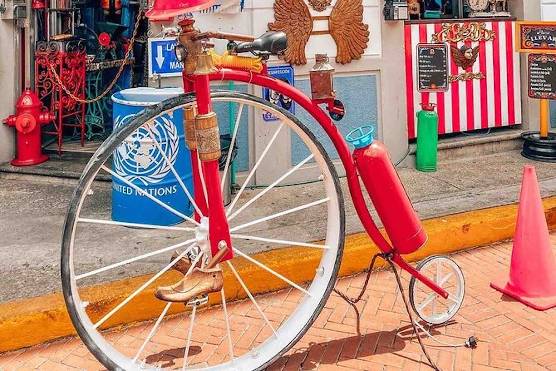 Casco Viejo Walking Tour image: vintage high-wheel bicycle displayed outside a colorful storefront