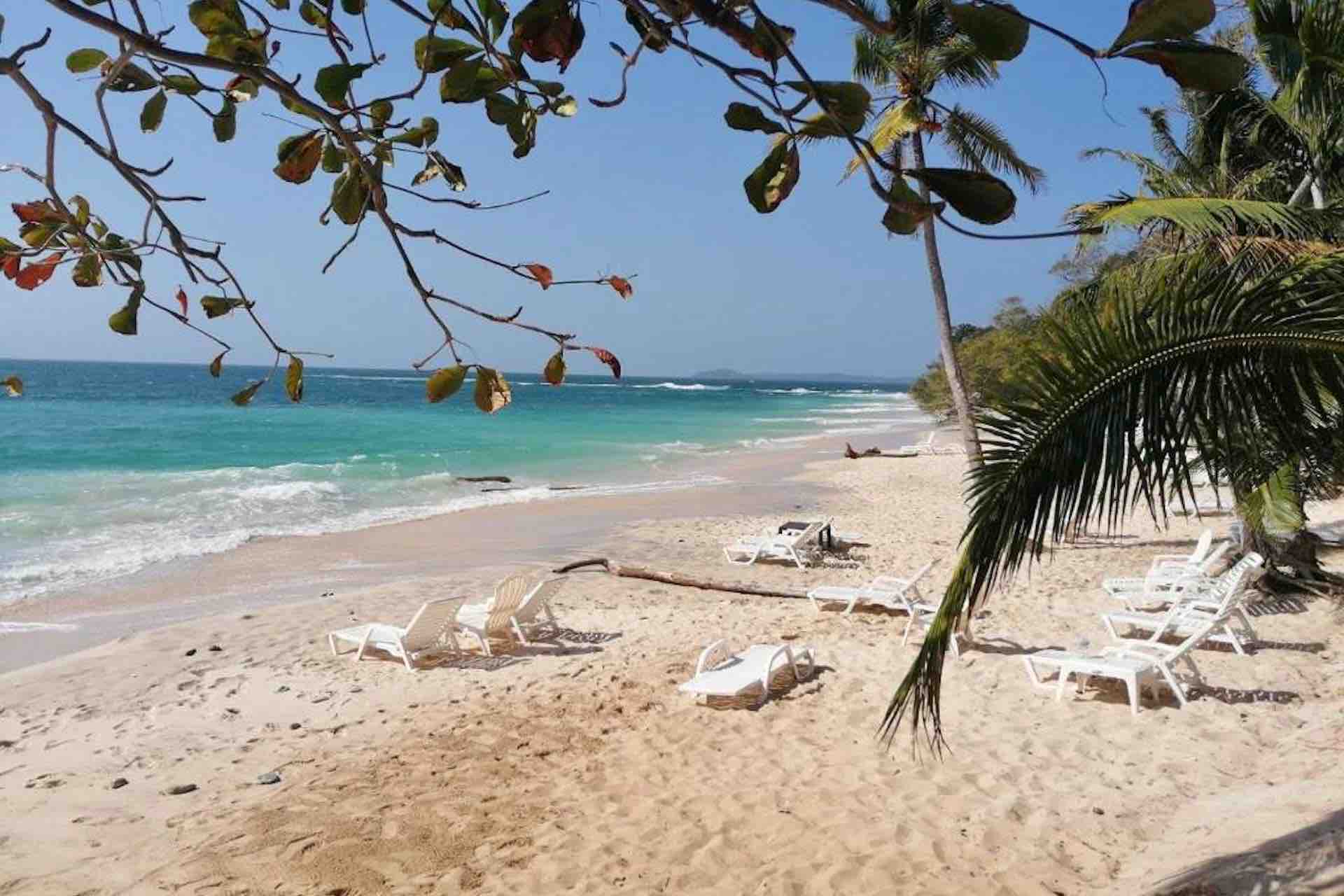 Sonny Island Resort Panama white sand beach with chairs