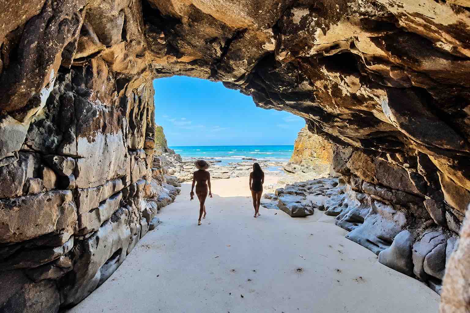 Guests walking through a coastal cave during a Pearl Islands Panama Day Trip