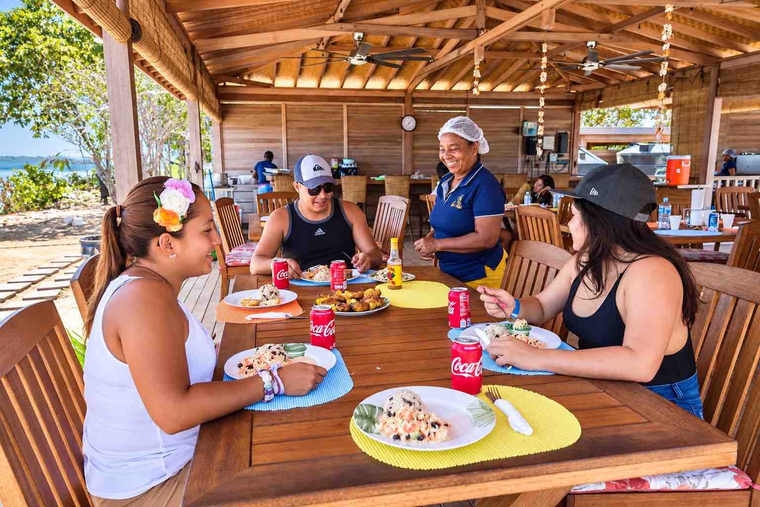 Guests enjoying a meal with resort staff during a Pearl Islands Panama Day Trip