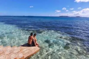 Isla Guasirdup San Blas Private Cabin Guests On Private Dock san blas islands, san blas tours panama travelers sitting on dock