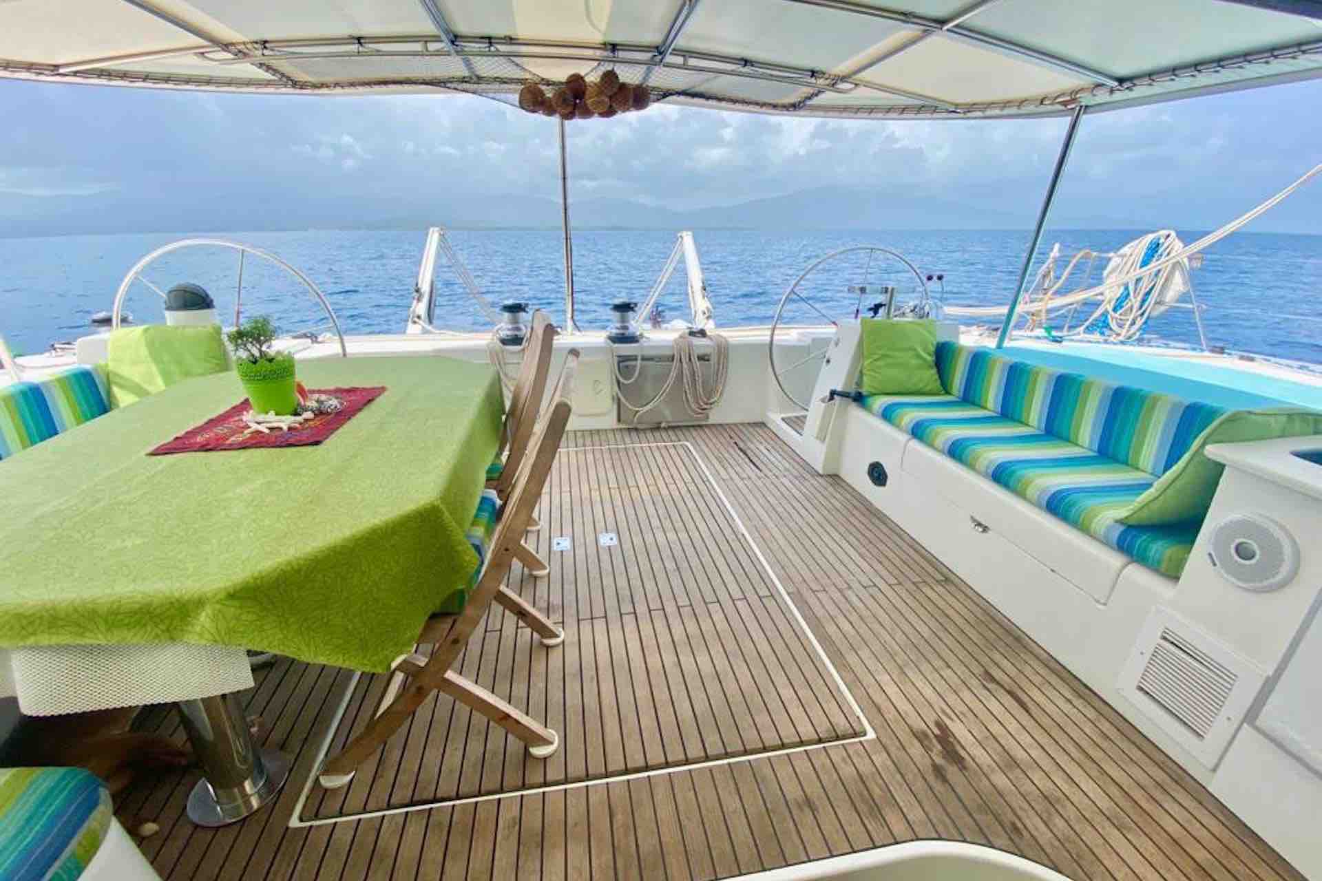 sail San Blas Sailing charter catamaran cockpit with table and fruit