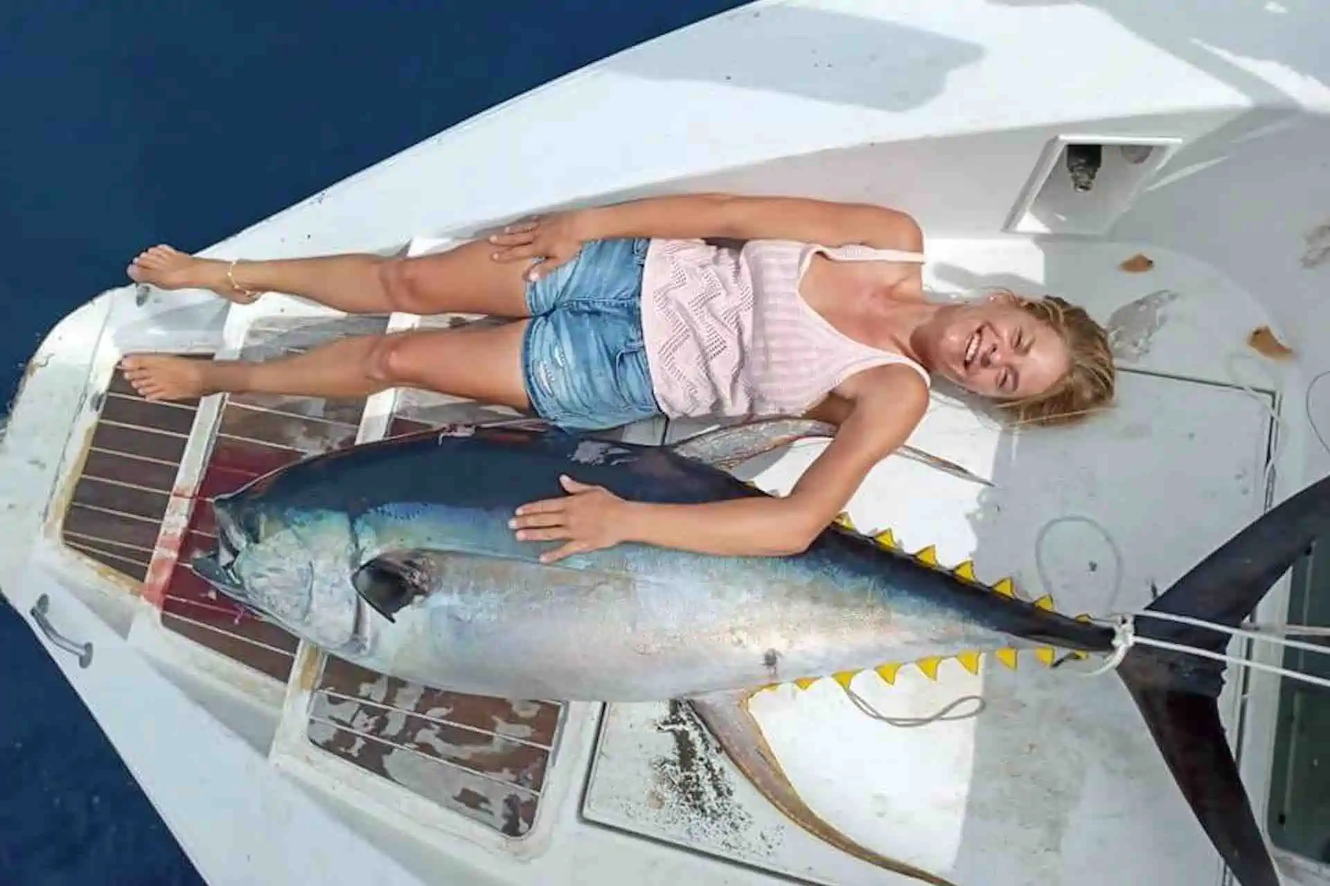 sail San Blas islands catamaran charter hige yellowfin tuna next to woman