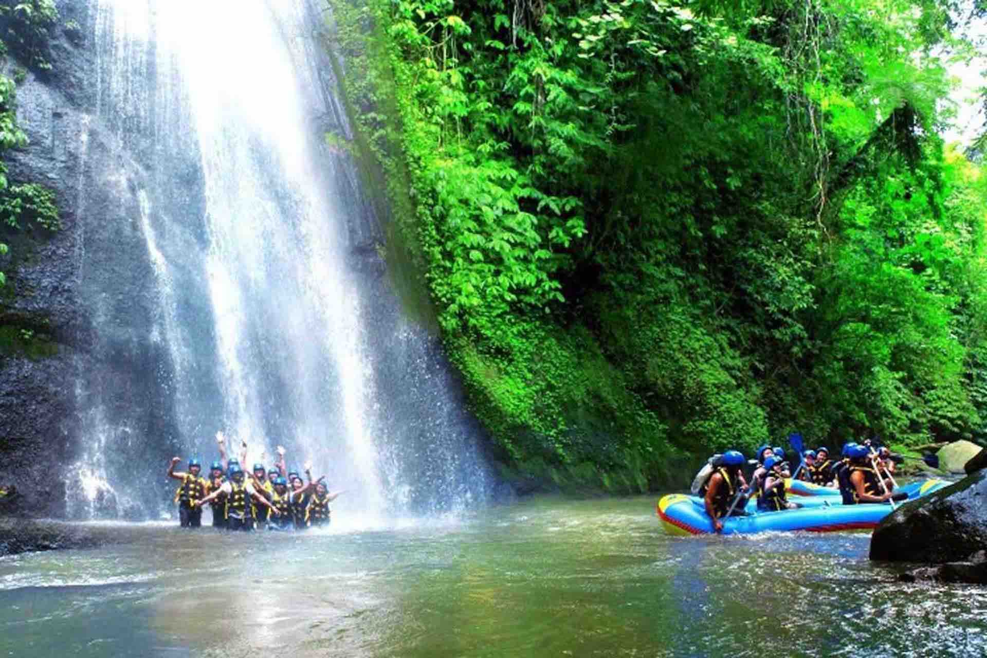 Bali River Rafting Ubud tour in Ayung river guests under waterfall stairs