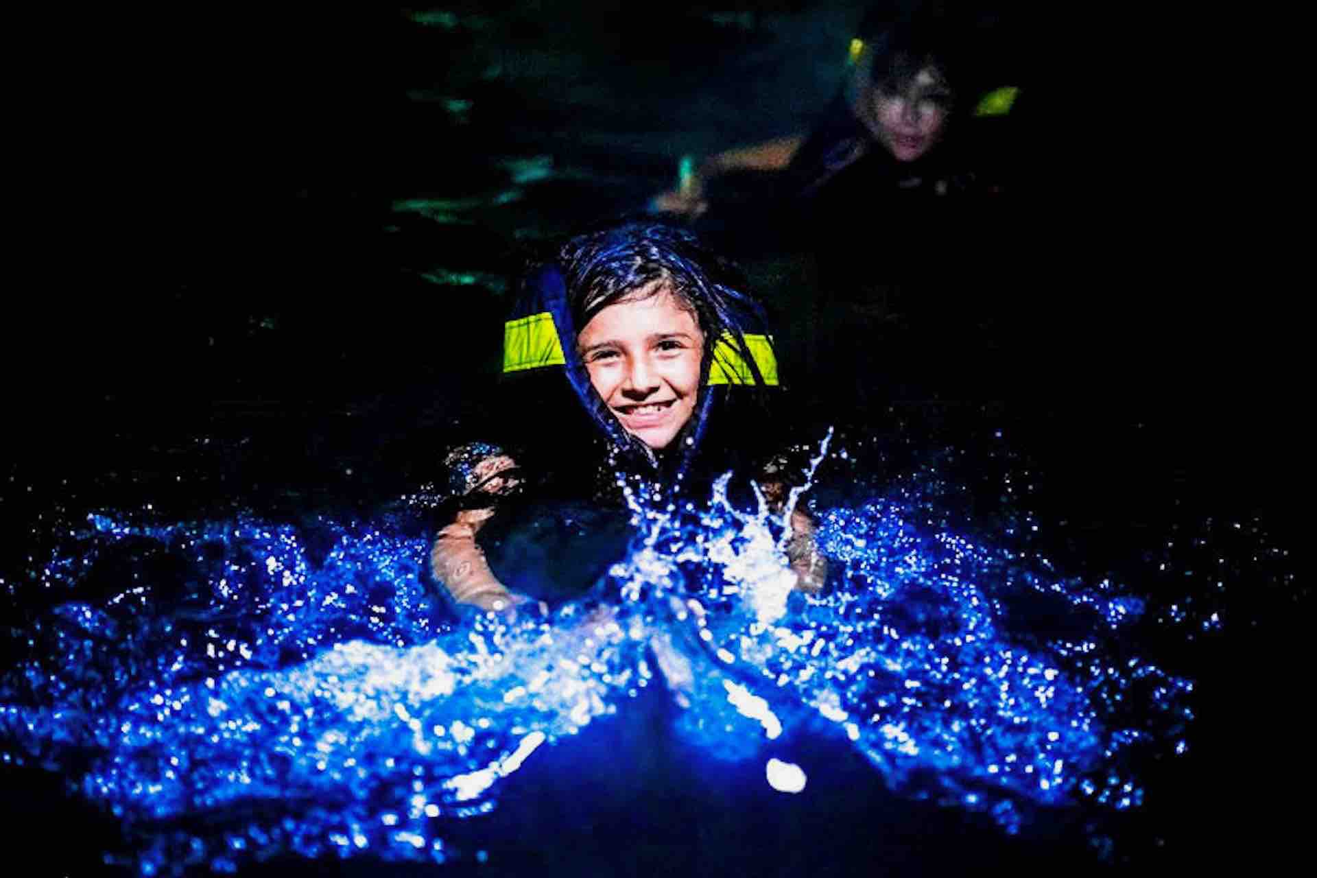Bocas del Toro bioluminescense tour child in water