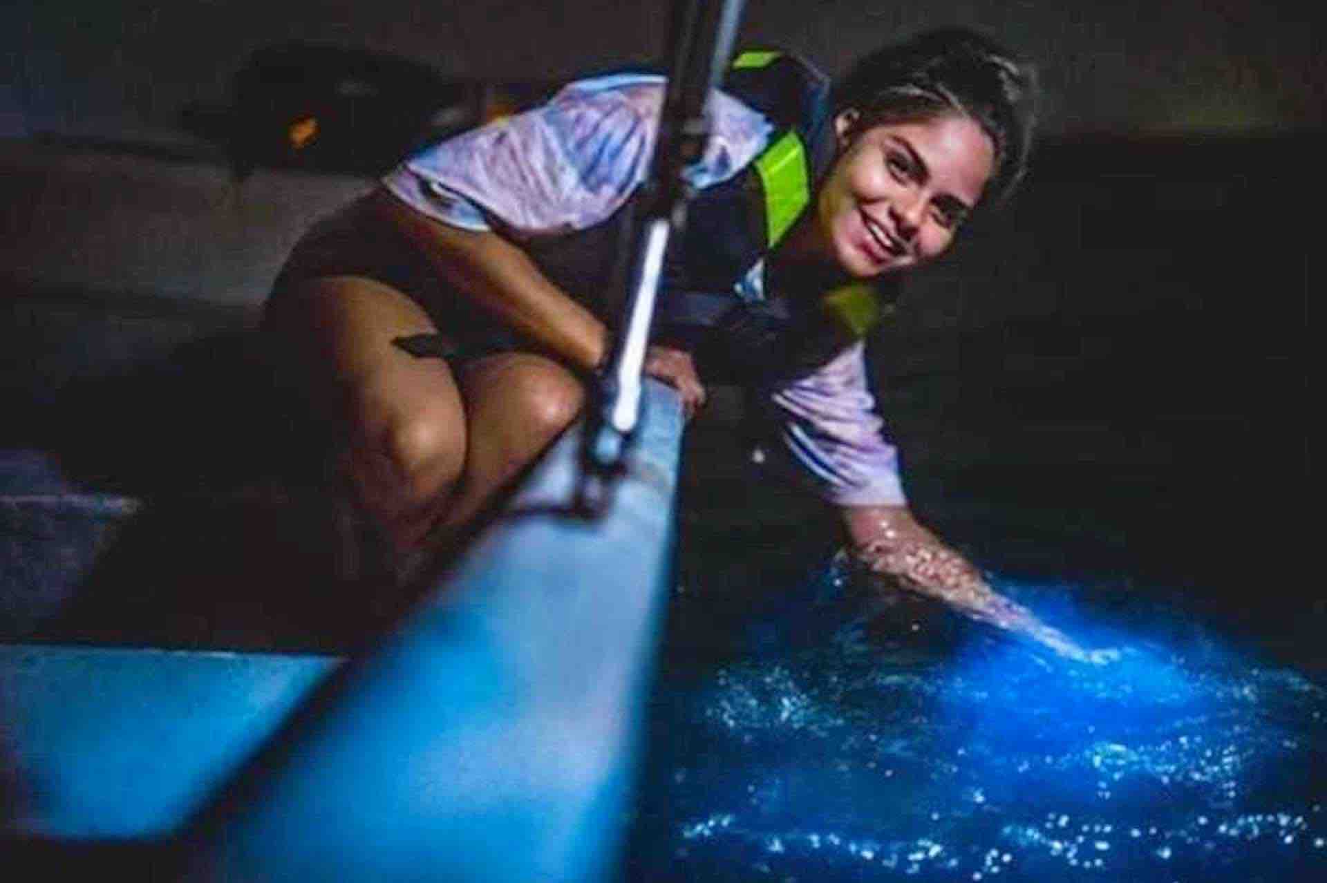 Bocas del Toro bioluminescense tour woman touching water