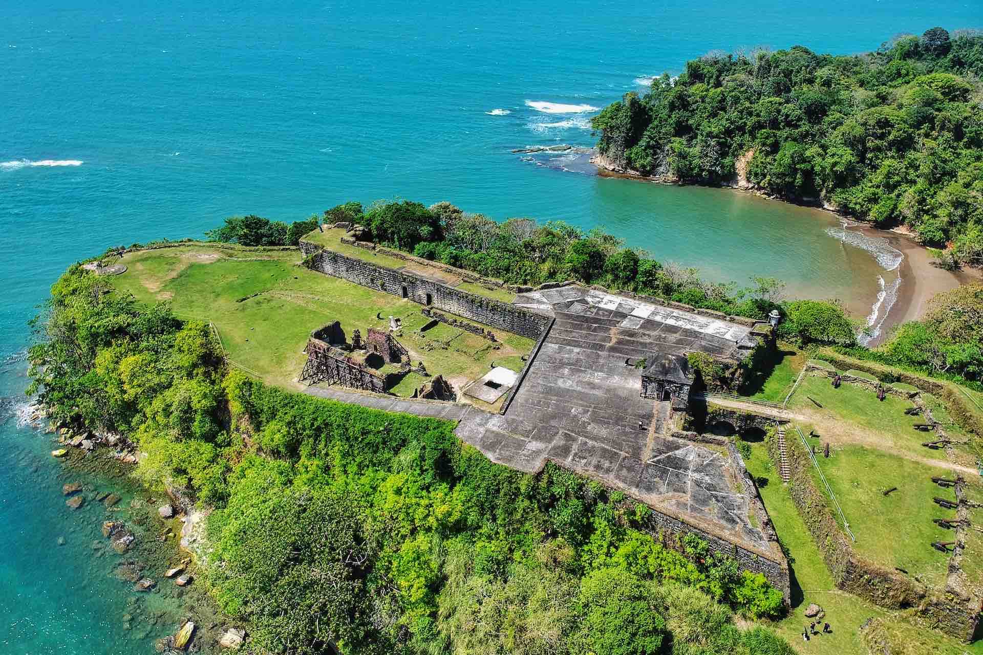 Aerial view of Fort San Lorenzo above the coastline and river mouth on the Ocean to Ocean Panama Canal Tour