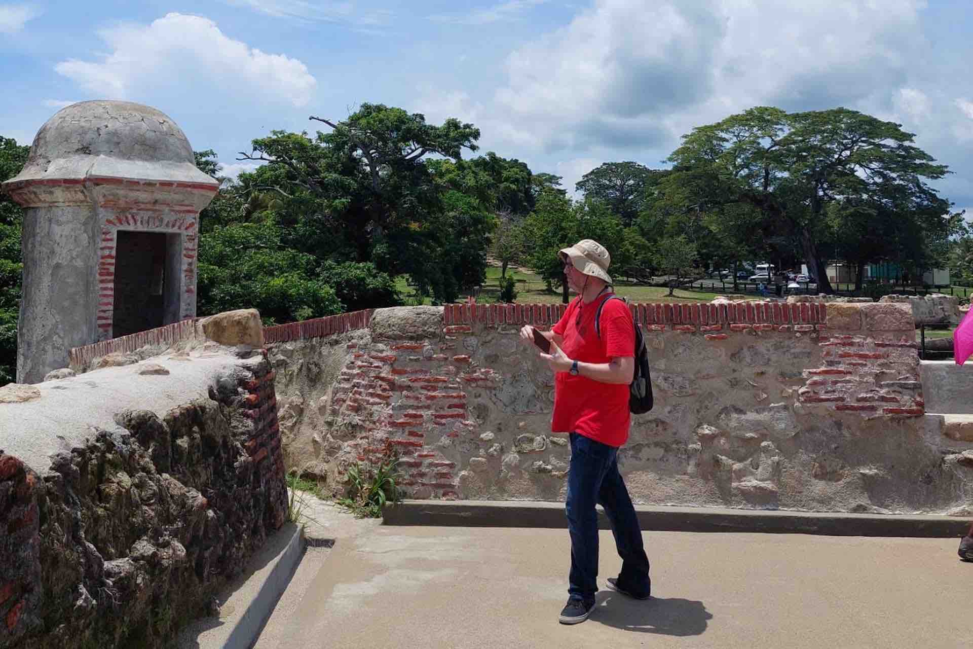 Guest exploring a stone terrace beside a sentry tower at Fort San Lorenzo on the Ocean to Ocean Panama Canal Tour