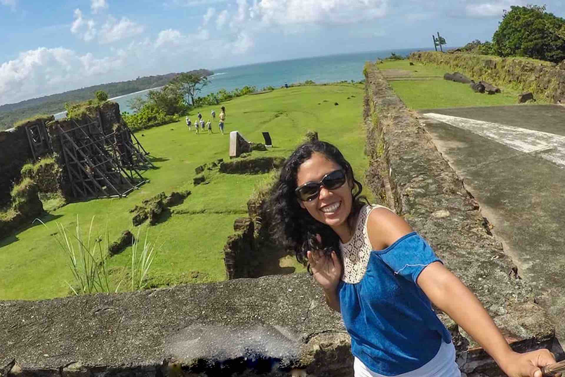 Guest taking a selfie above Fort San Lorenzo’s grassy grounds and stone walls on the Ocean to Ocean Panama Canal Tour