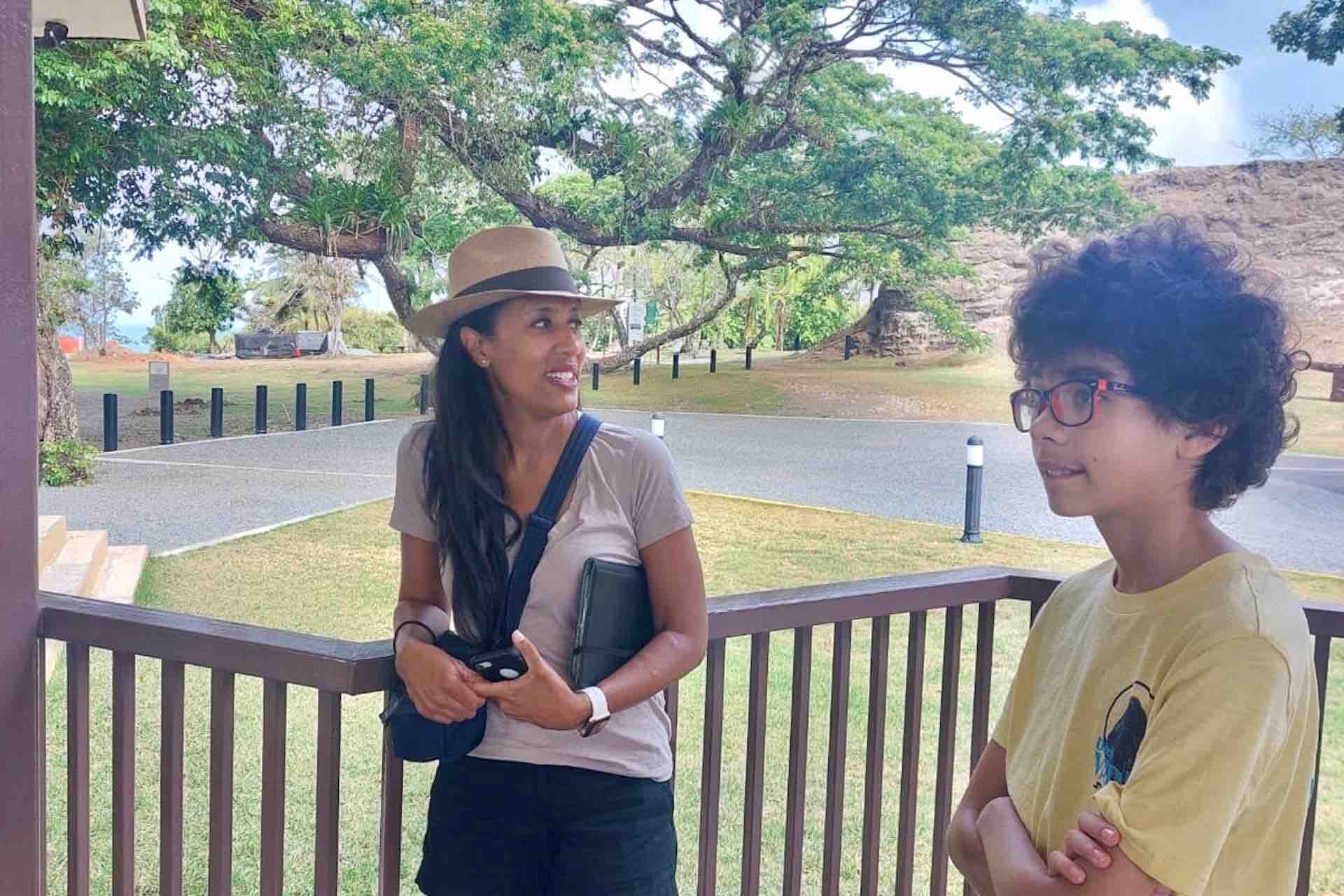 Two guests talking beside a shaded railing near Fort San Lorenzo on the Ocean to Ocean Panama Canal Tour