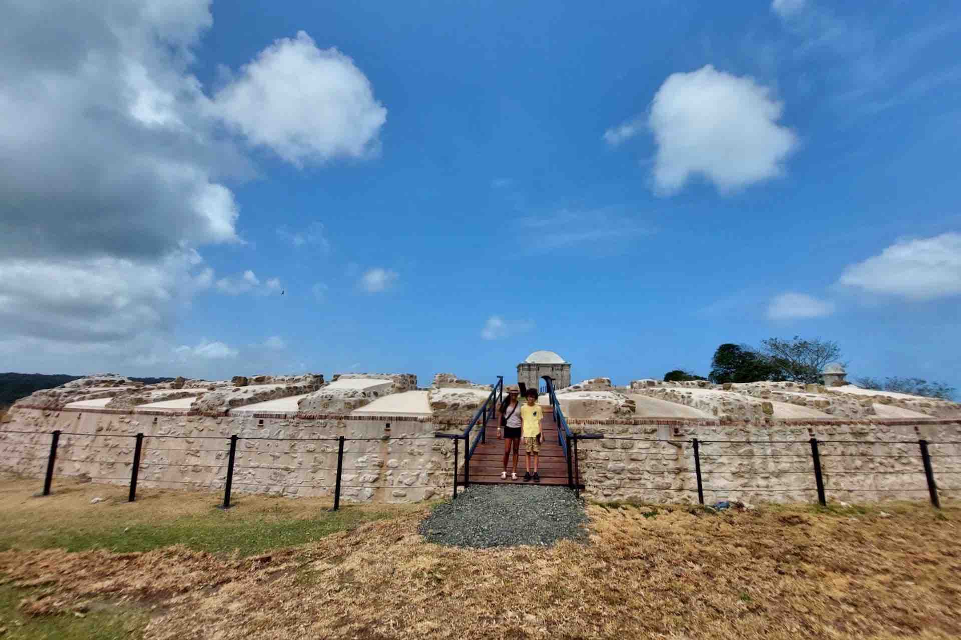 Guests standing near the entrance in Fort San Lorenzo’s stone fortifications on the Ocean to Ocean Panama Canal Tour