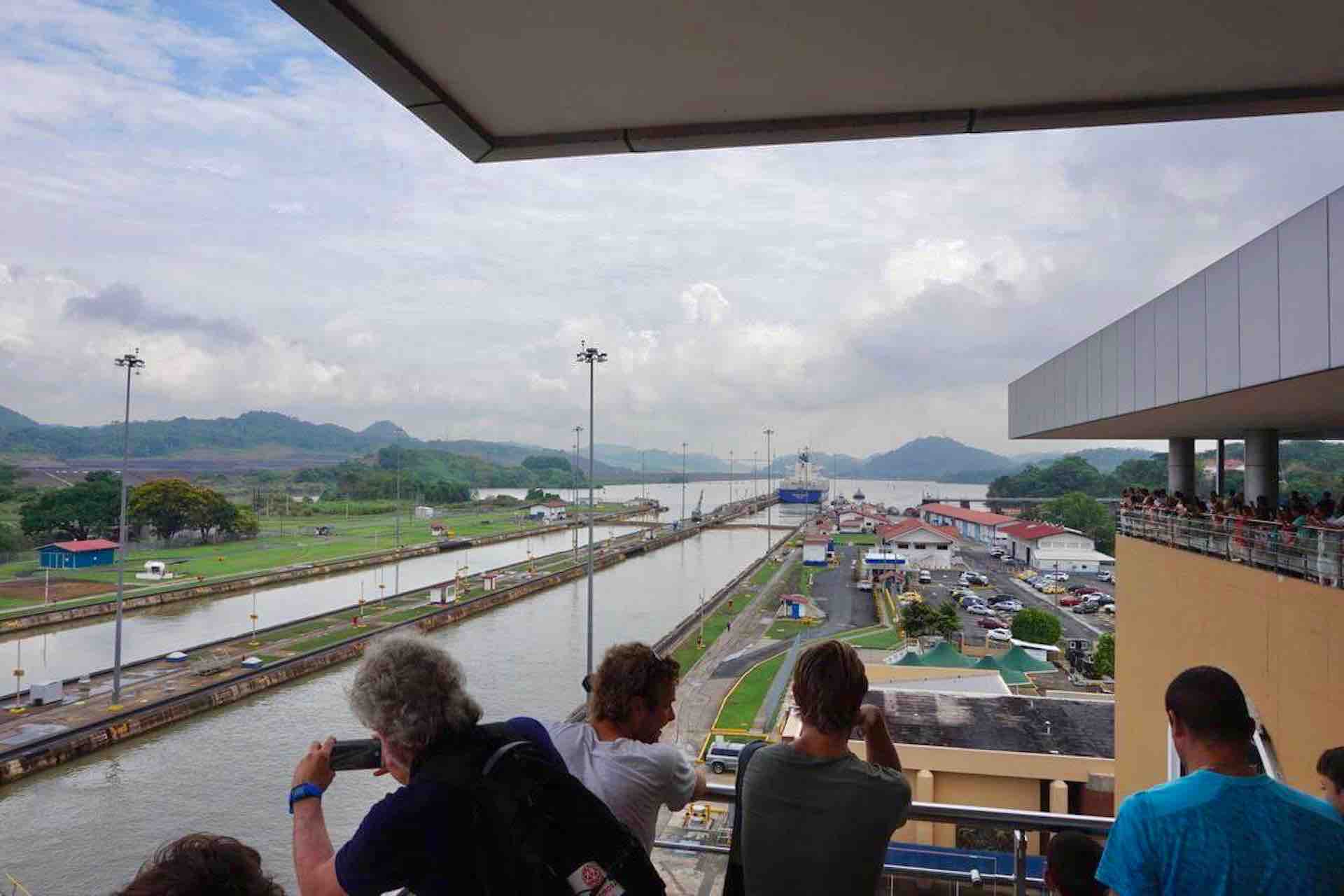 Visitors photographing Panama Canal locks from a covered viewing terrace on the Ocean to Ocean Panama Canal Tour