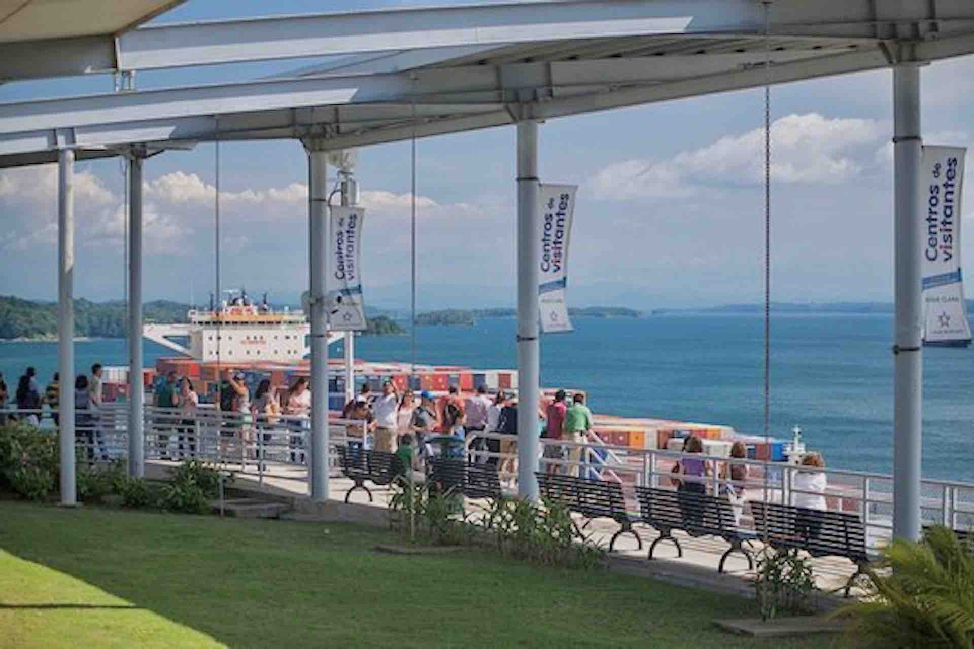 Visitors gathered beneath a covered viewing platform overlooking the Panama Canal on the Ocean to Ocean Panama Canal Tour
