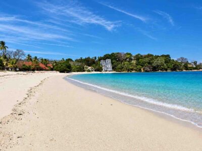 Pimienta Y Sal – Playa Larga Sandy Shoreline Pimienta y Sal – Sandy beach curving beside turquoise water and buildings at Playa Larga