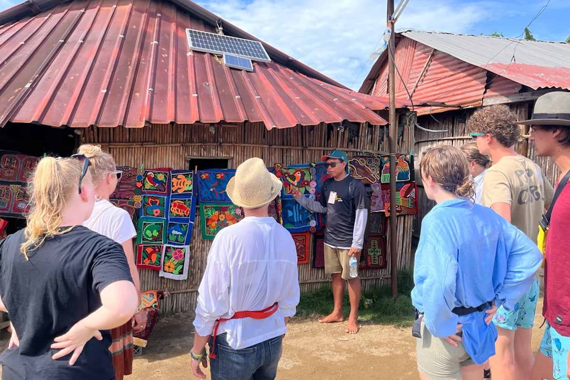 San Blas Panama Kuna community tour guide explaining about Molas
