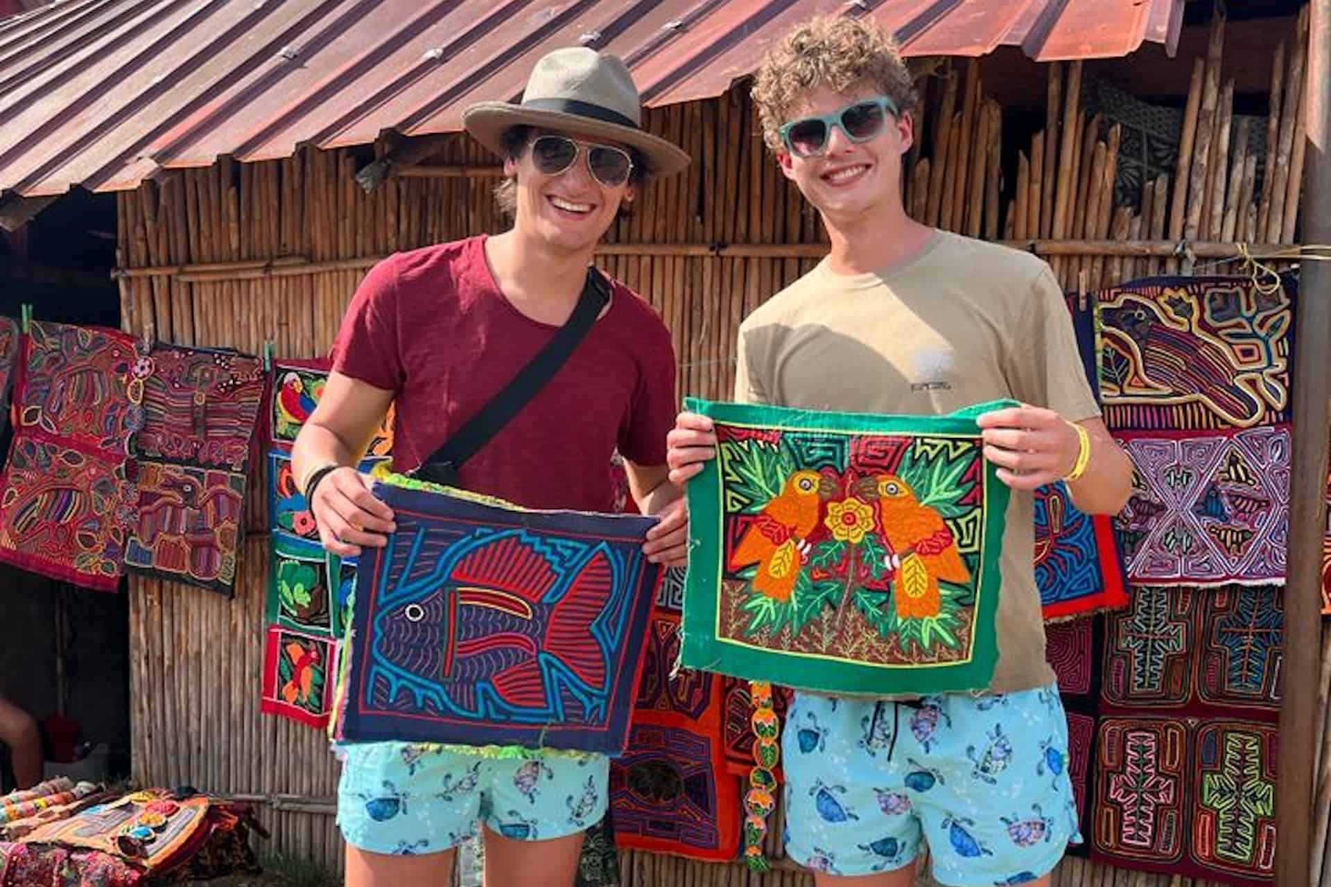 San Blas Panama Kuna happy tour guests showing off their Mola artwork