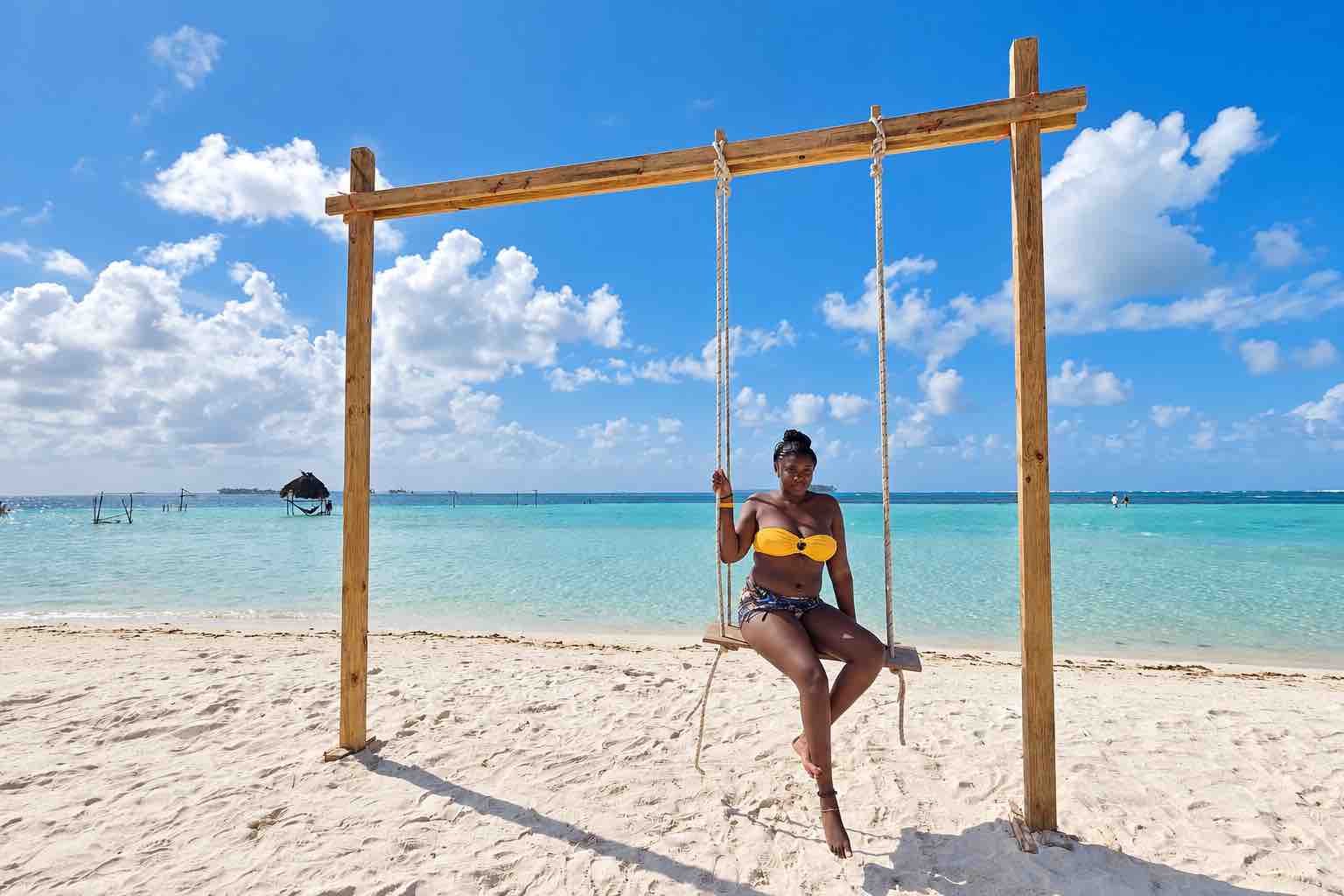 Guest on a beach swing beside turquoise water during a San Blas Islands tour from Panama City