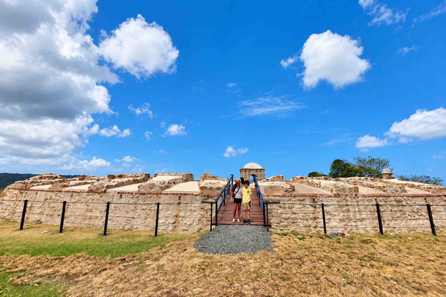 Visitors at the entrance to a historic fortification.
