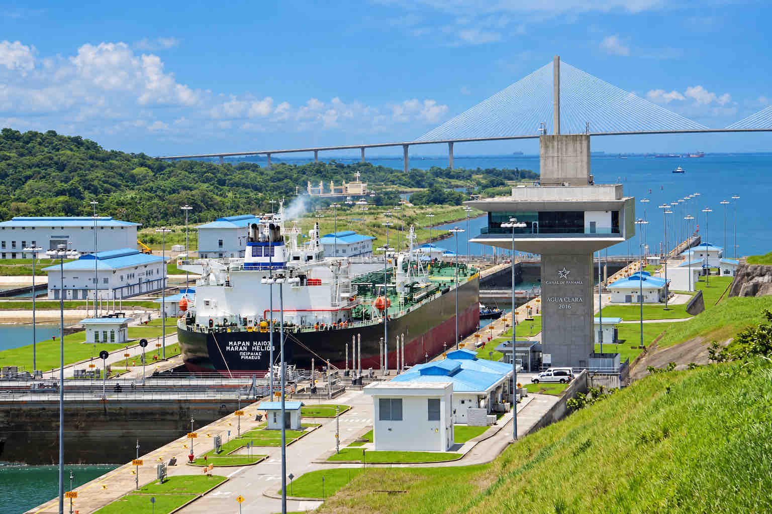 Cargo ship in Agua Clara Locks with the Atlantic Bridge in the background.