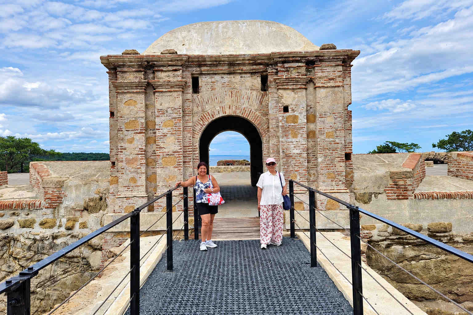 Two guests standing at the entrance to a historic San Lorenzo fort on a Panama Canal Shore Excursion from Colón