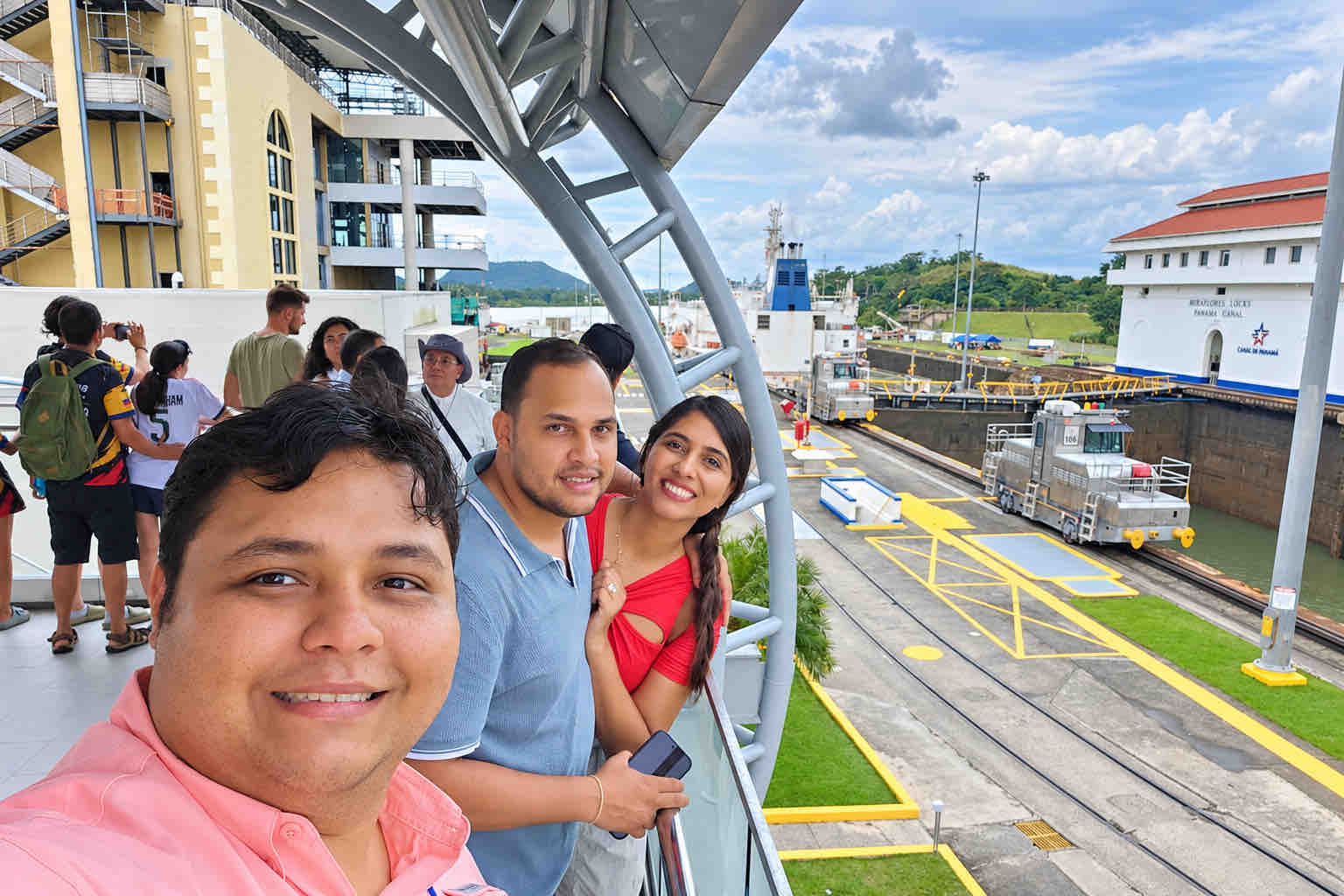 Guide and guests taking a selfie overlooking the Miraflores Locks on a Panama Canal Shore Excursion from Colón
