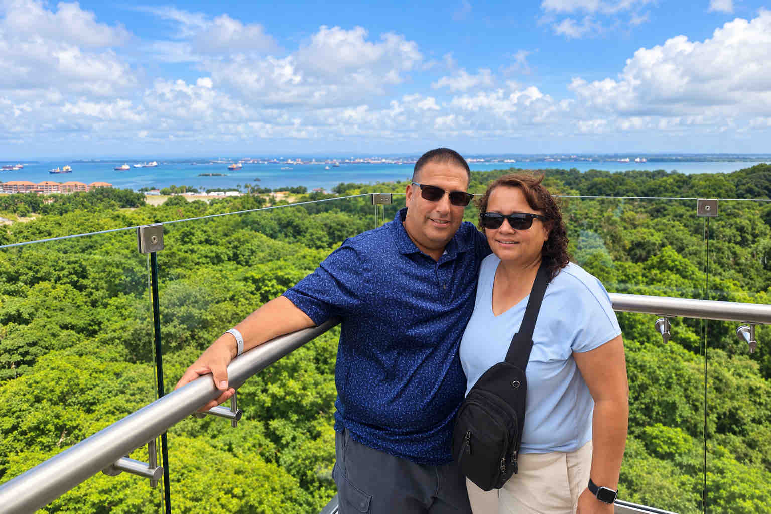 Couple at a viewpoint overlooking forest and ocean on a Panama tour