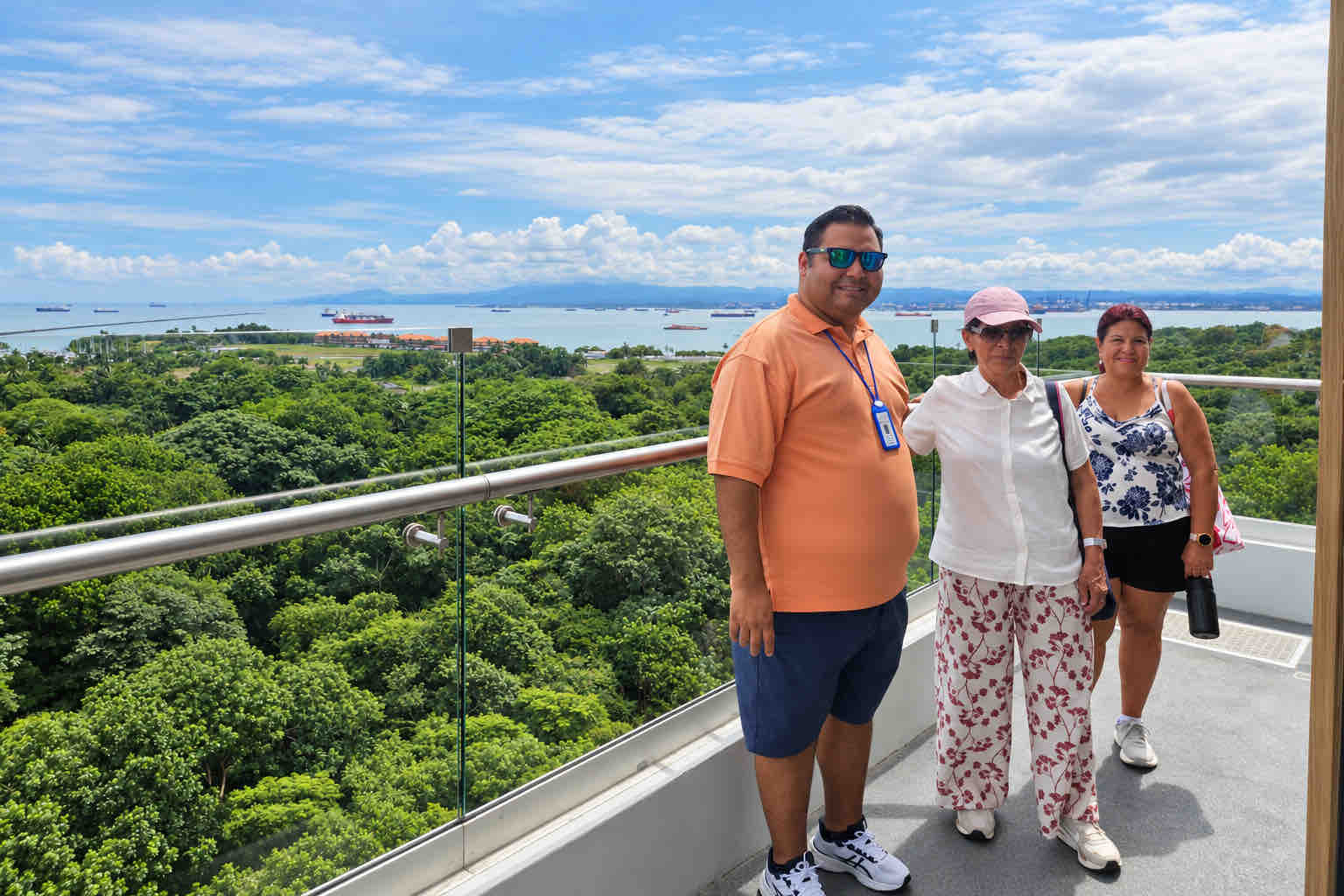 Guide and guests at a viewpoint above forest and ocean on a Panama Canal Shore Excursion from Colón