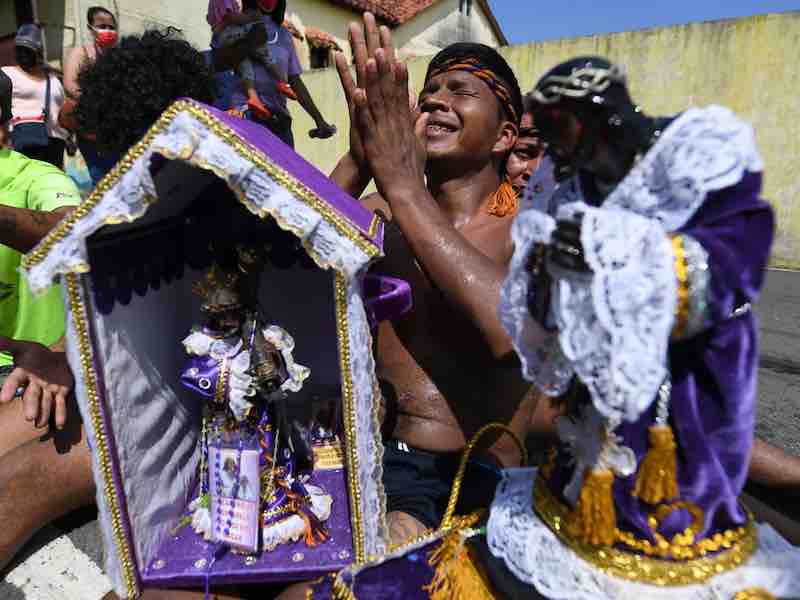 Pilgrimage for the Black Christ of Portobelo Devotees praying to the Black Christ statue during procession in Portobelo, Black Christ Festival Panama, Cristo Negro Portobelo, Religious pilgrimage Panama
