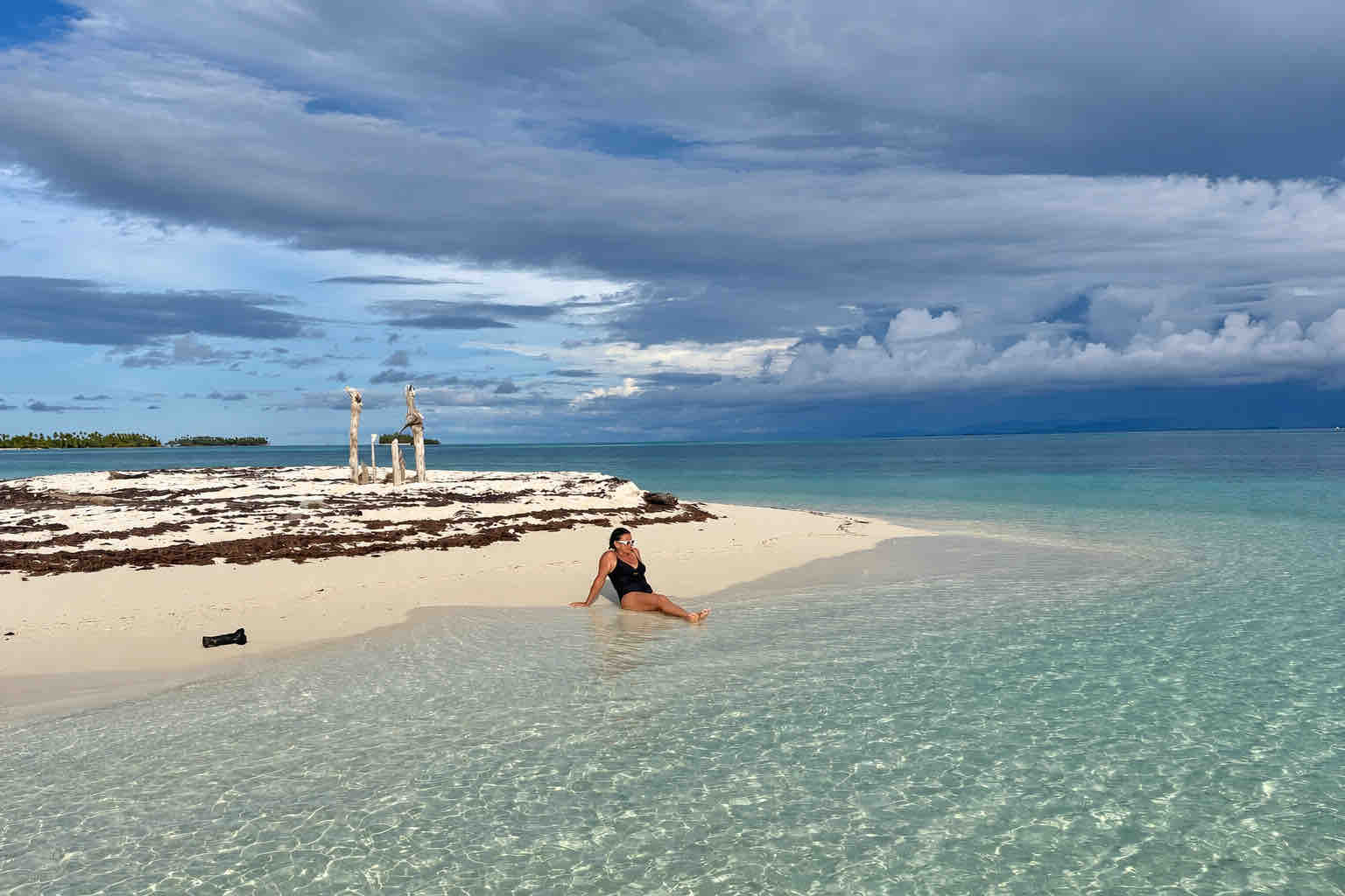 Guest relaxing at the edge of a calm San Blas beach