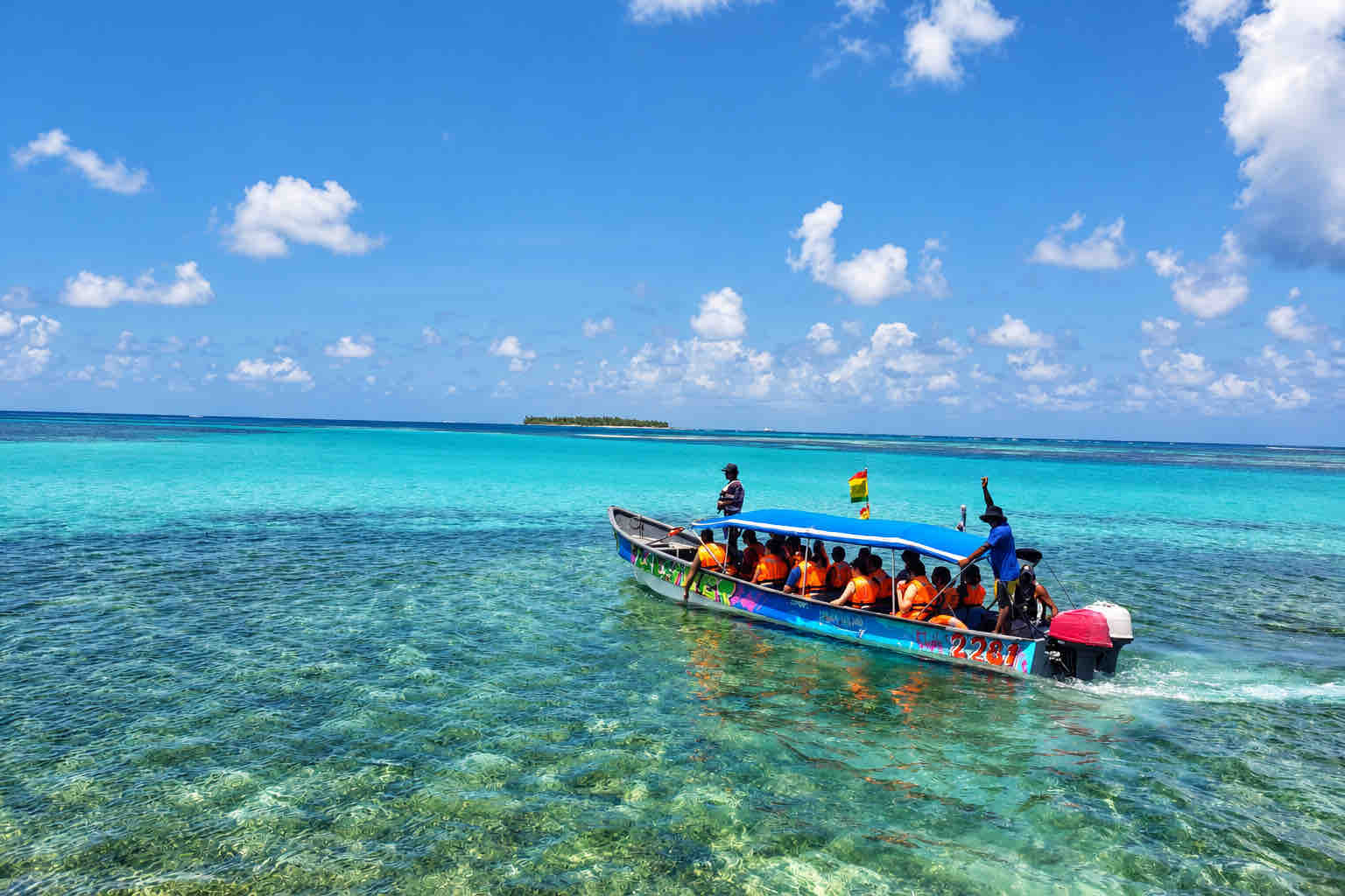 Guests wearing orange life jackets aboard a covered boat on a San Blas tour.