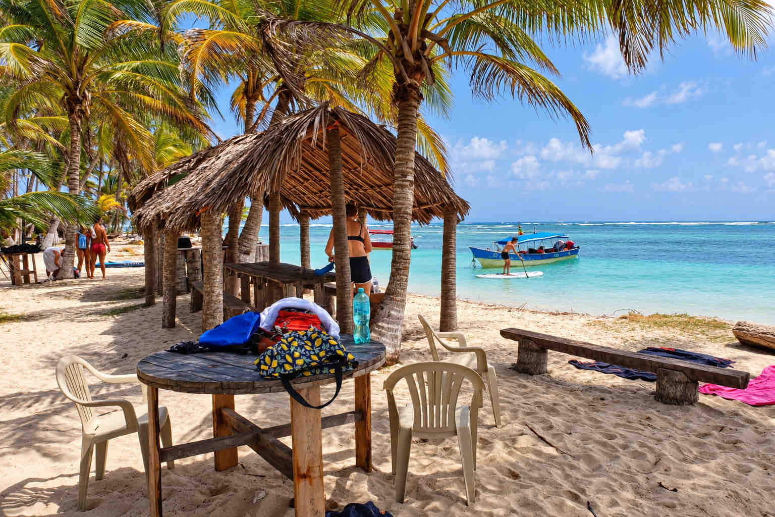 Thatched beach shelter and a wooden table beside the sea on a San Blas tour.